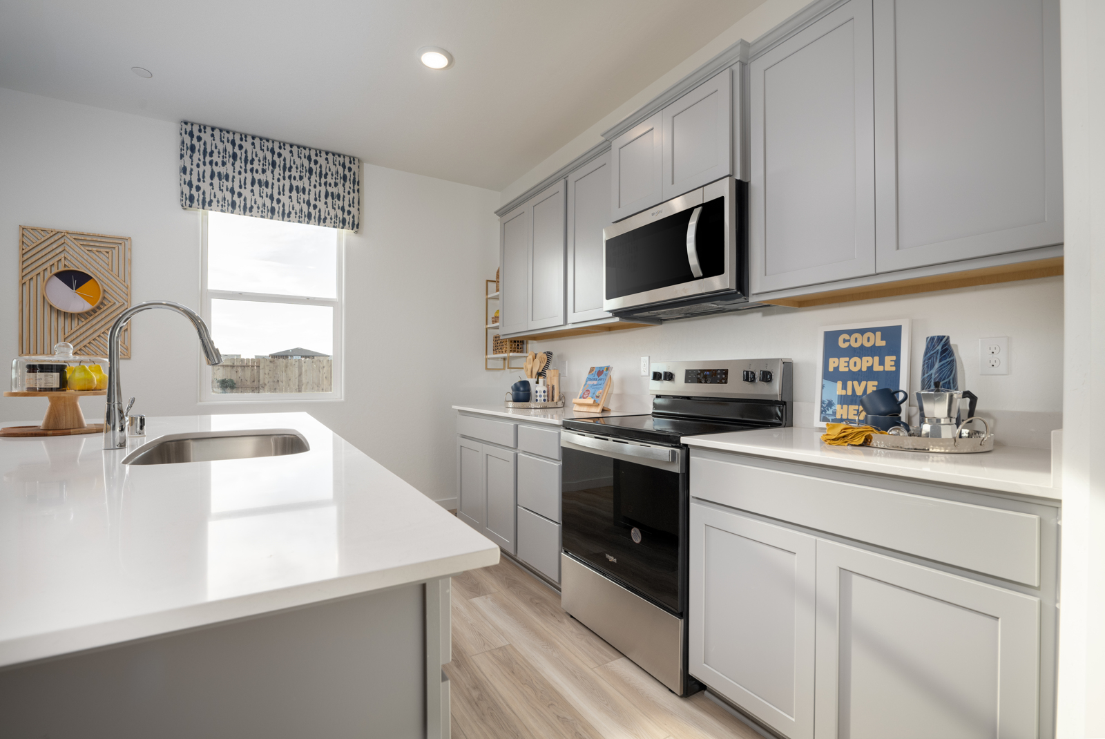 A kitchen with white cabinets.