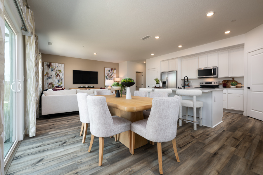 A kitchen with a table and chairs.
