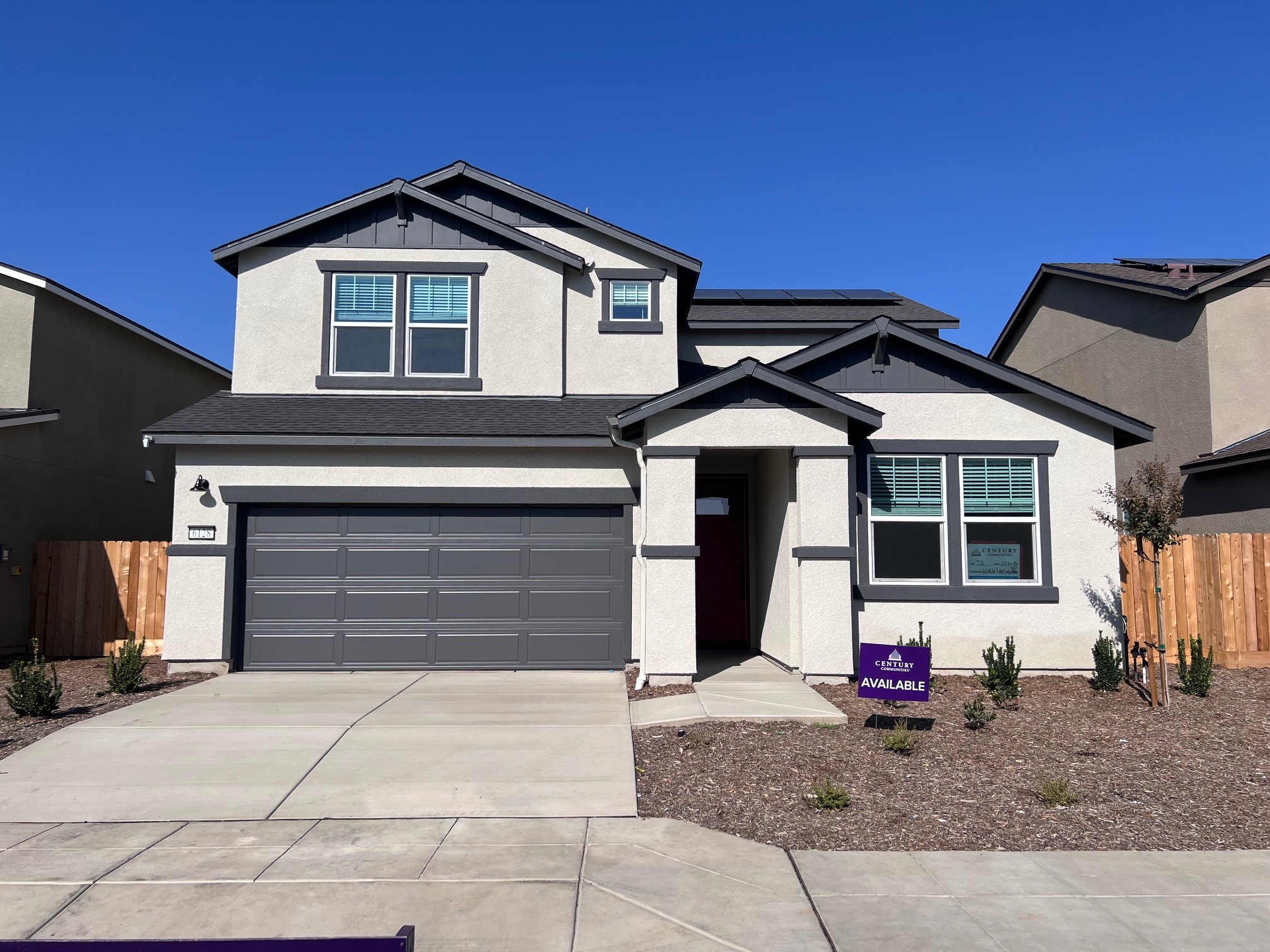A house with garages and a brick driveway.