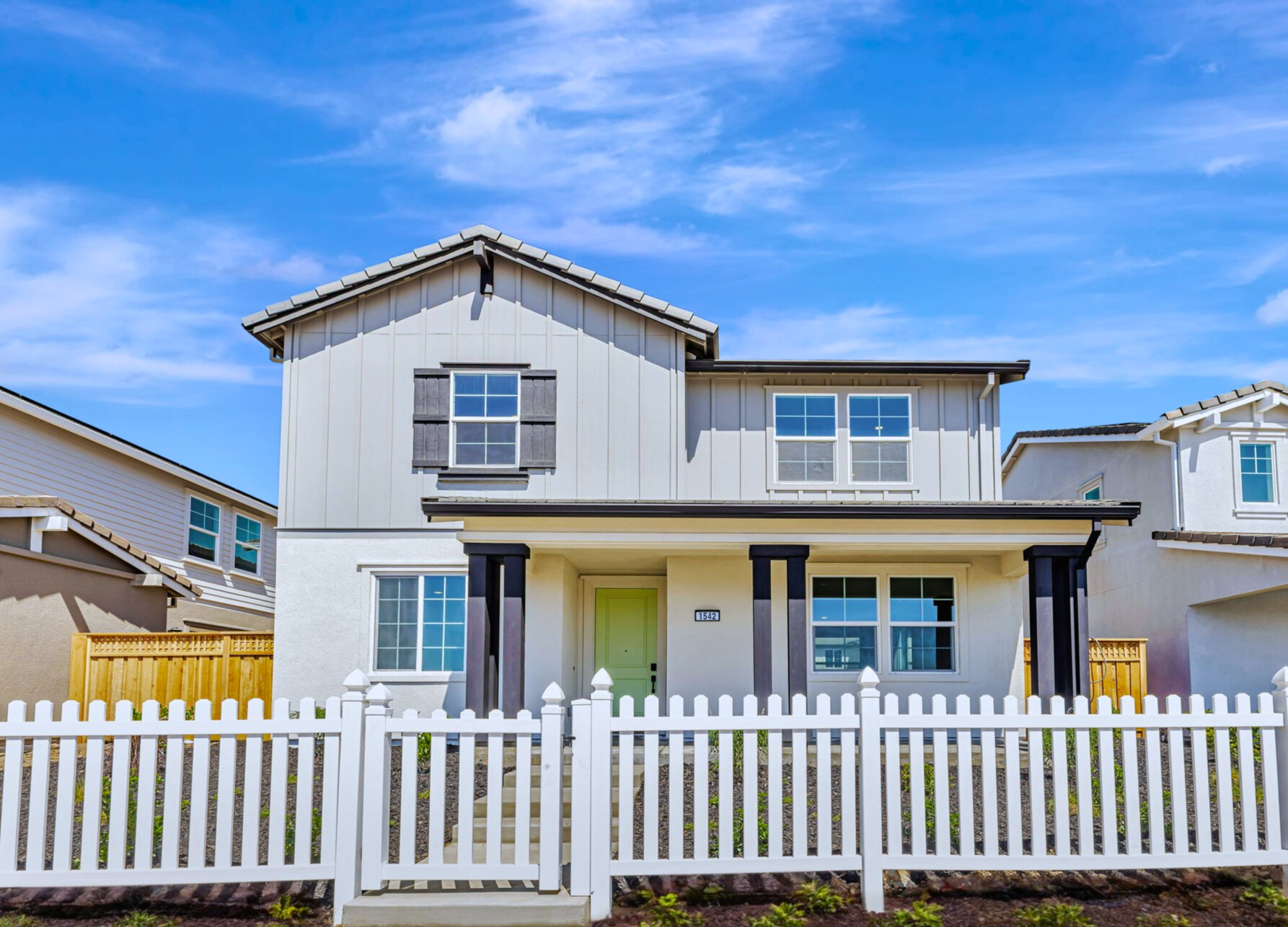A white house with a fence.