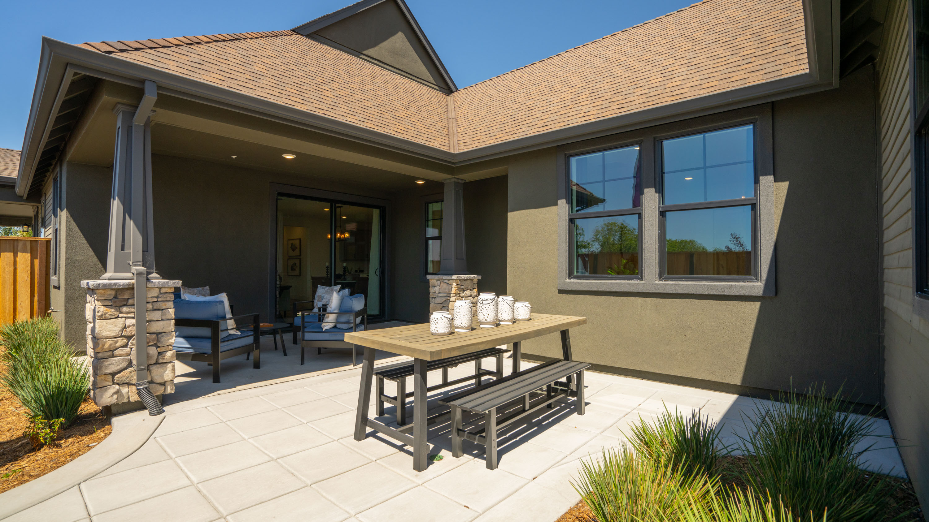 A house with a patio and a table and chairs.