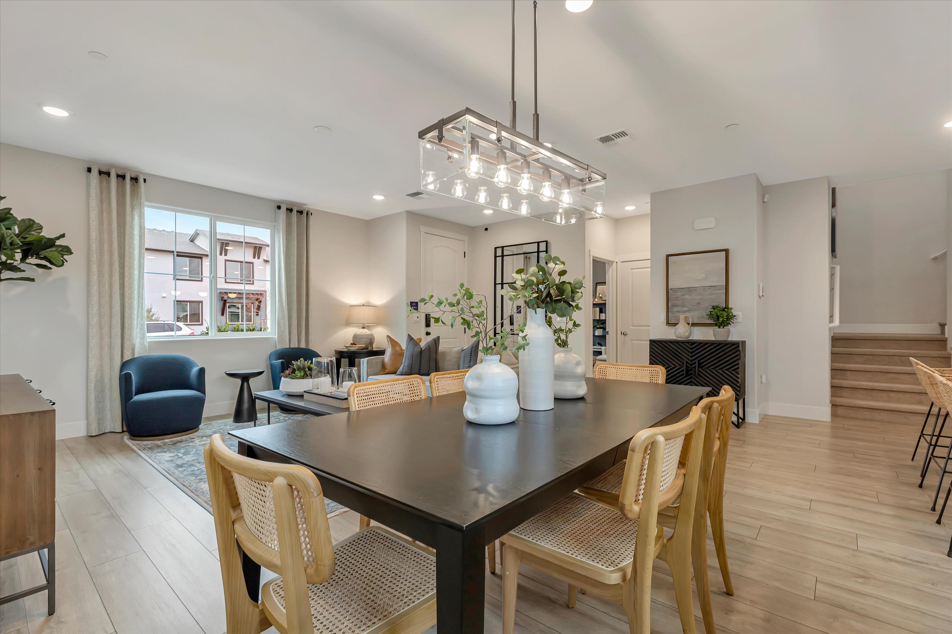 A dining room with a chandelier and a table.