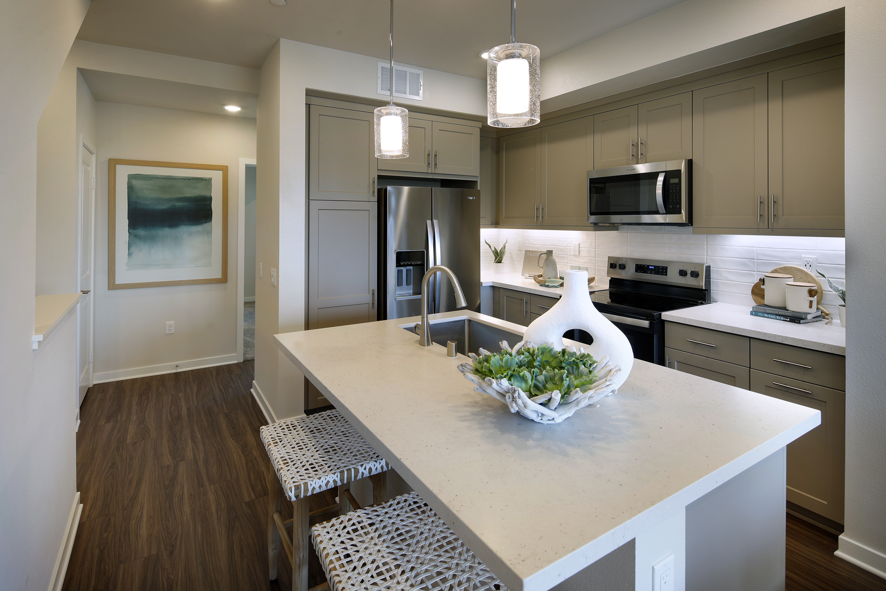 A kitchen with a table and chairs.