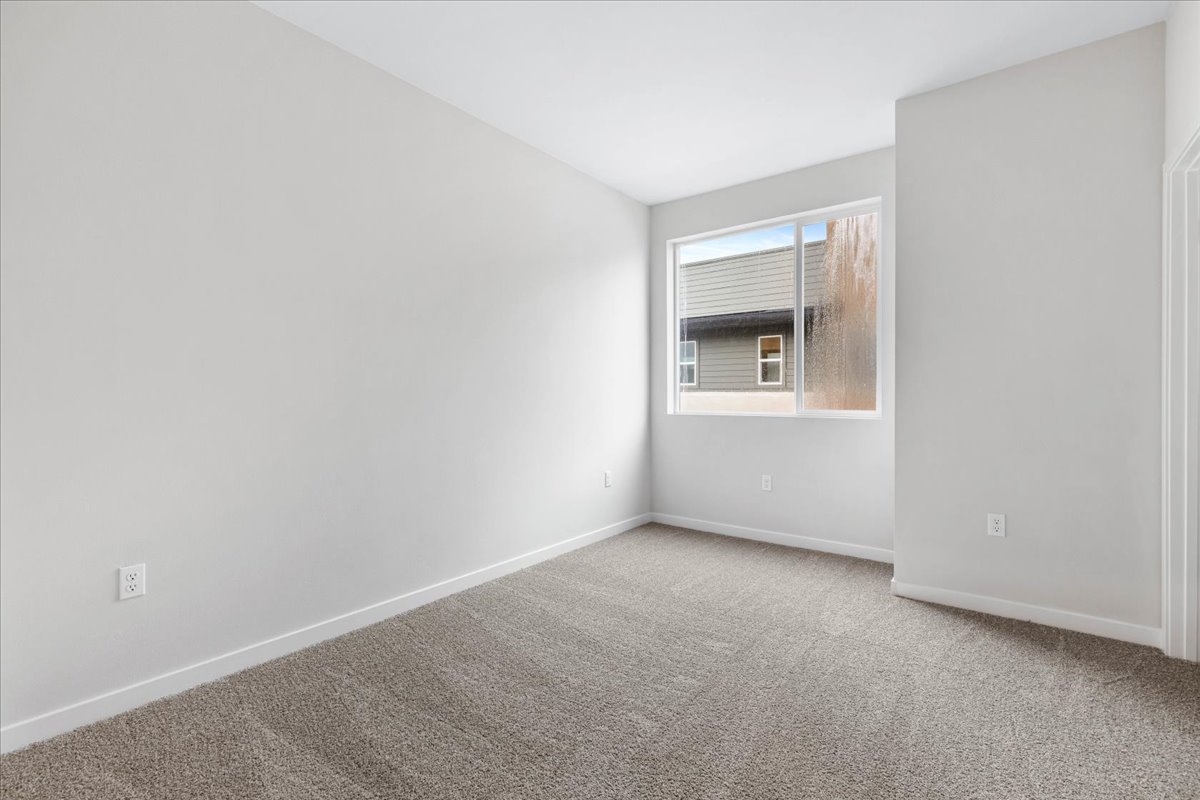 A room with a window and carpet.