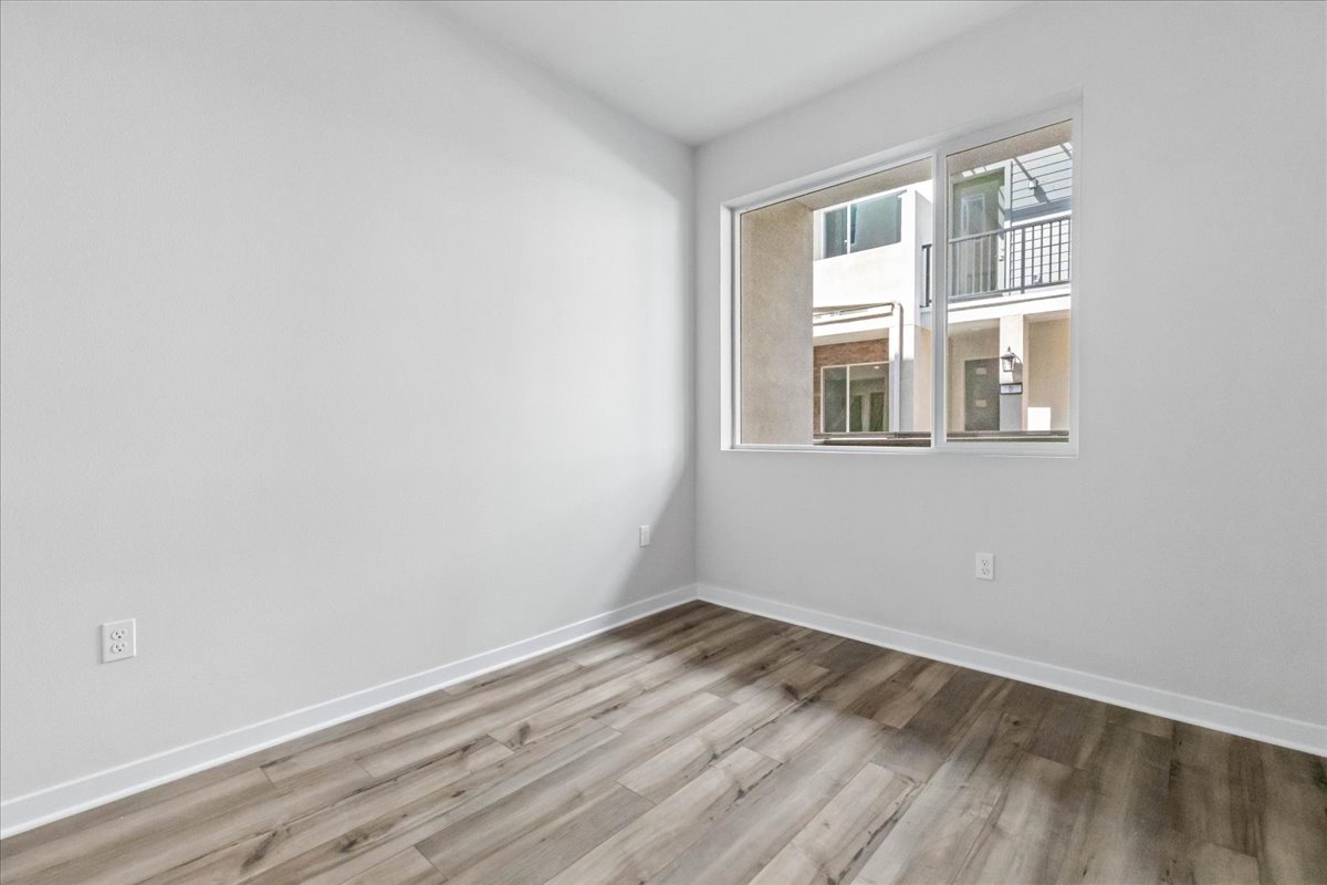 A room with a wood floor and a window.