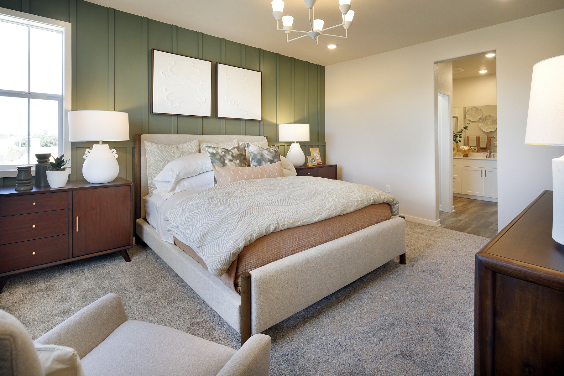 A bedroom with a bed and lamps.