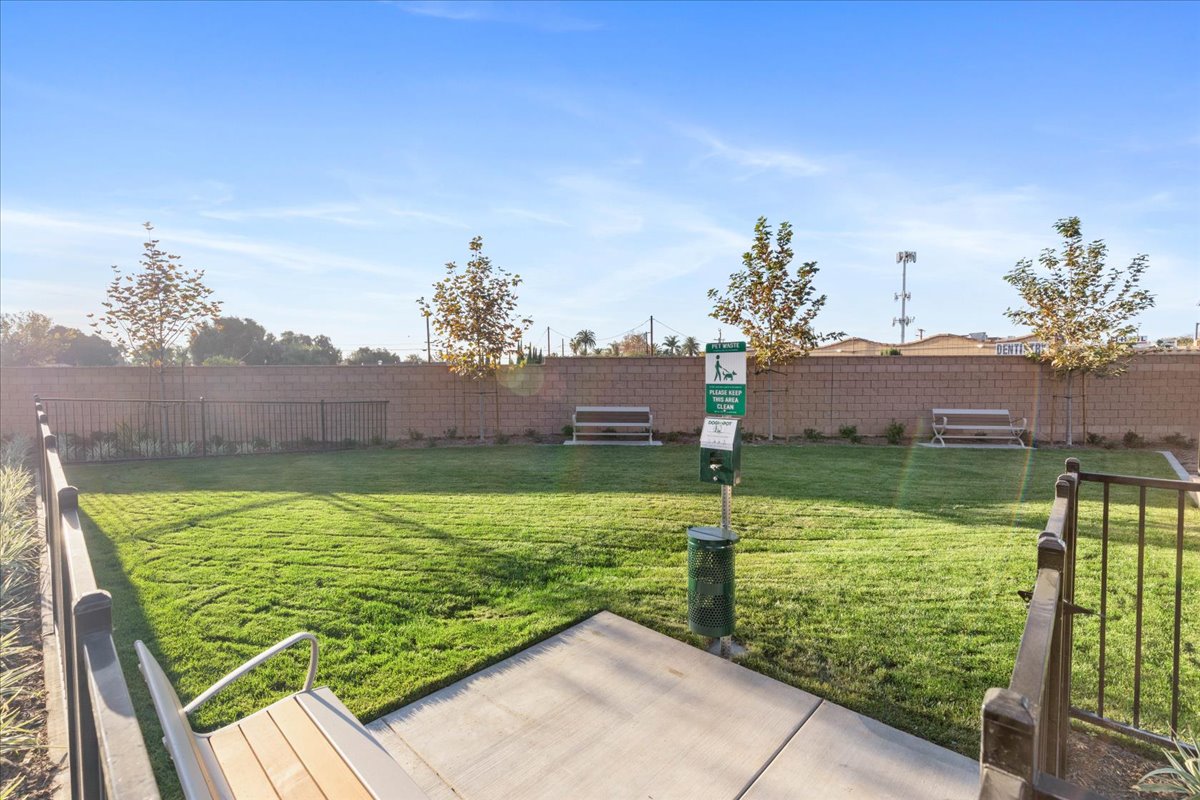 A fenced in area with a sign and a bench in the middle.