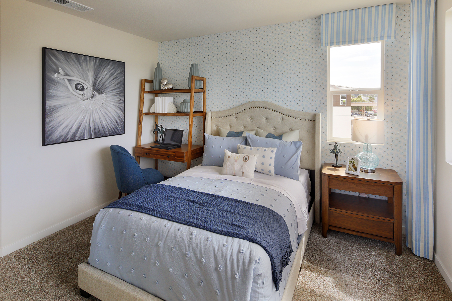 A bedroom with a bed and a desk.