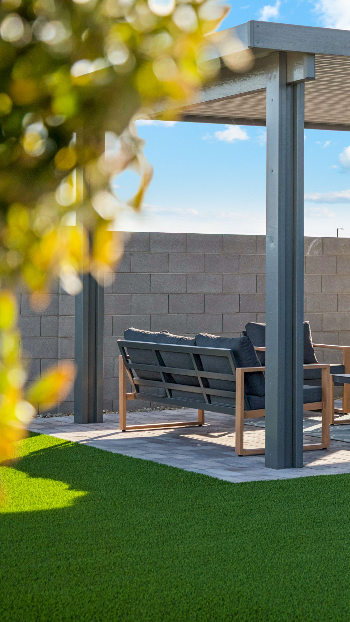 Marion floor plan model backyard with attached ramada, covered patio, and turf with patio furniture - New construction homes for sale Goodyear AZ Resort style amenities & founder incentives to the lucky few first homeowners.