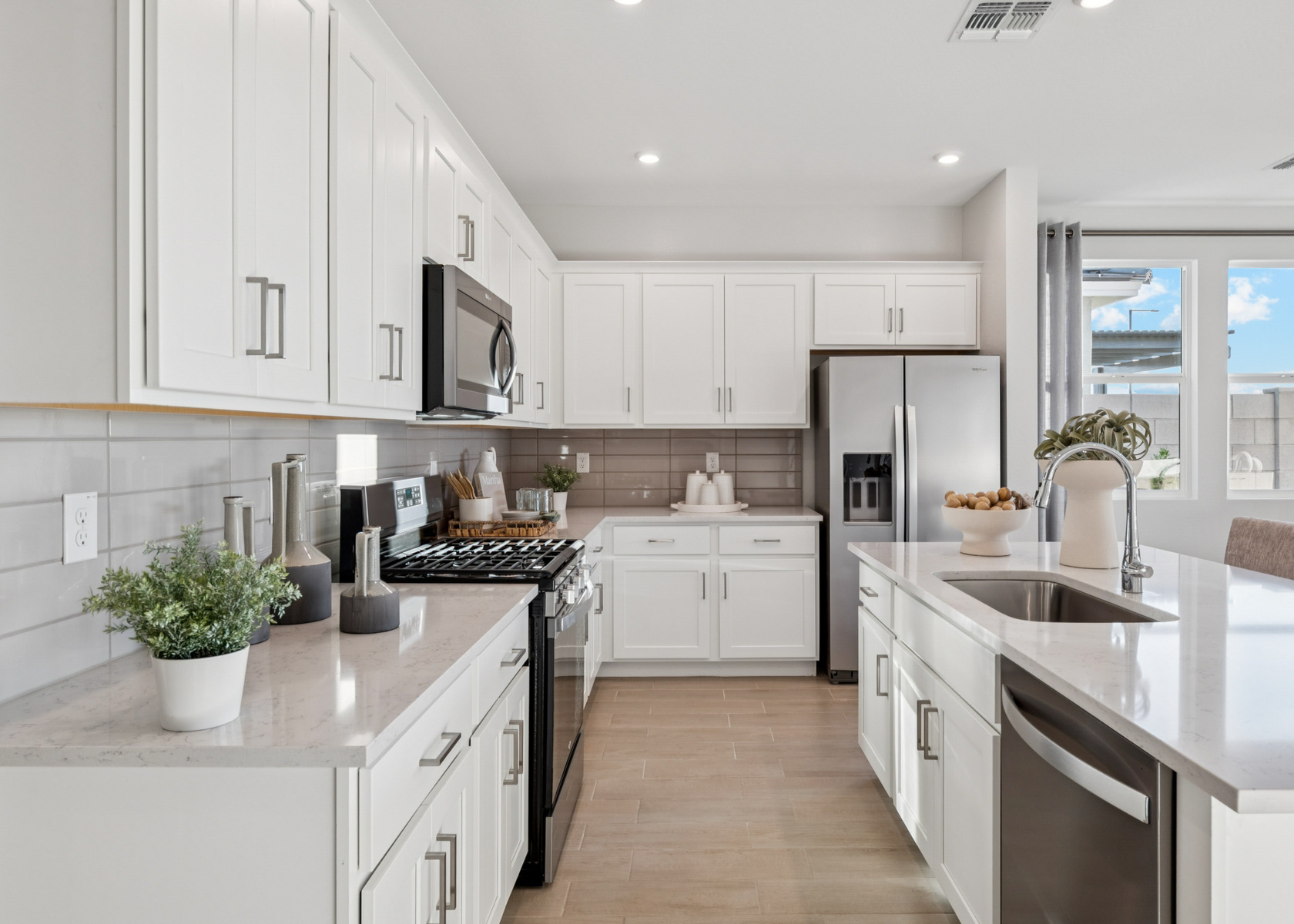 A kitchen with white cabinets.