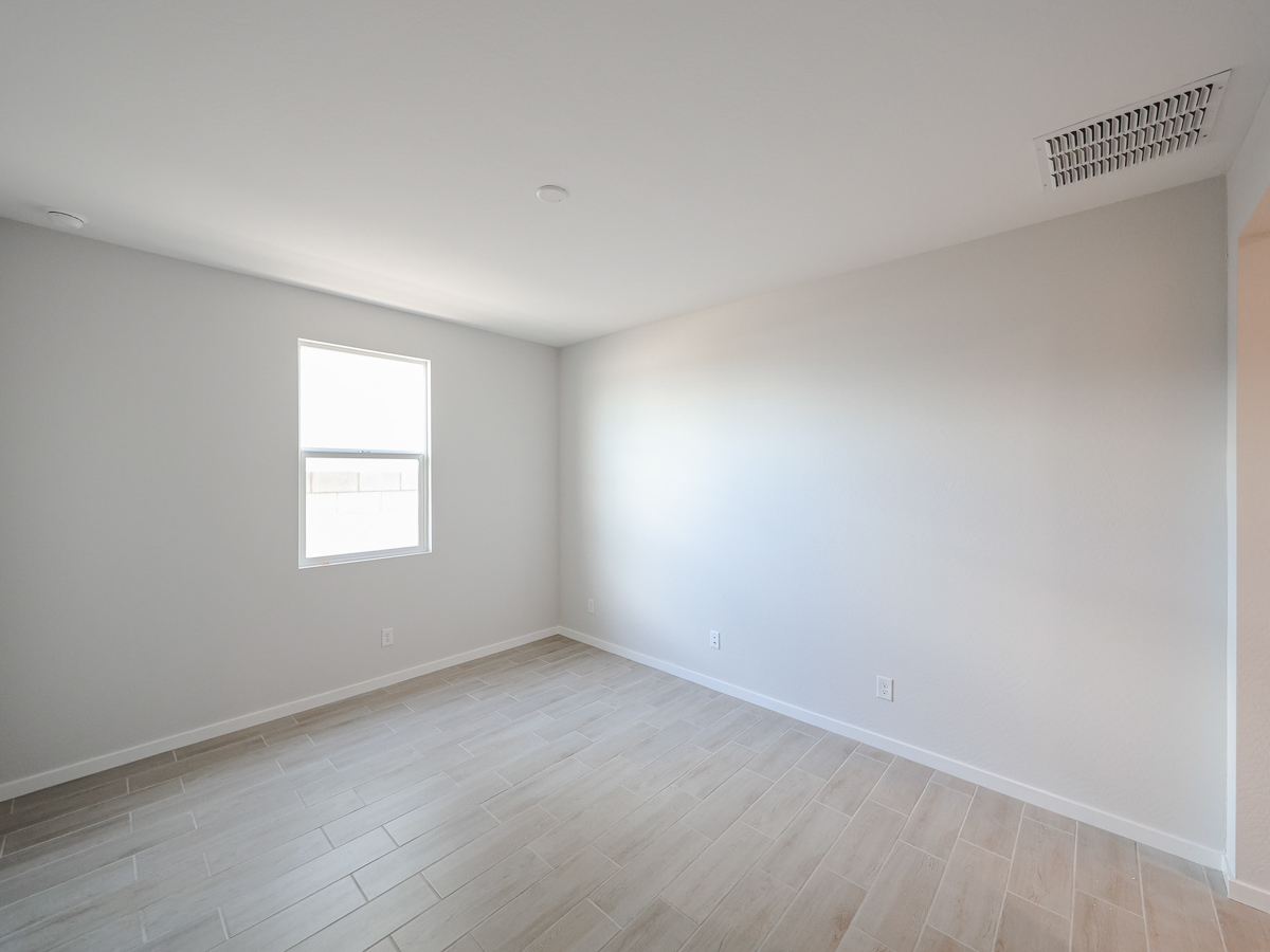 A room with a wood floor and windows.