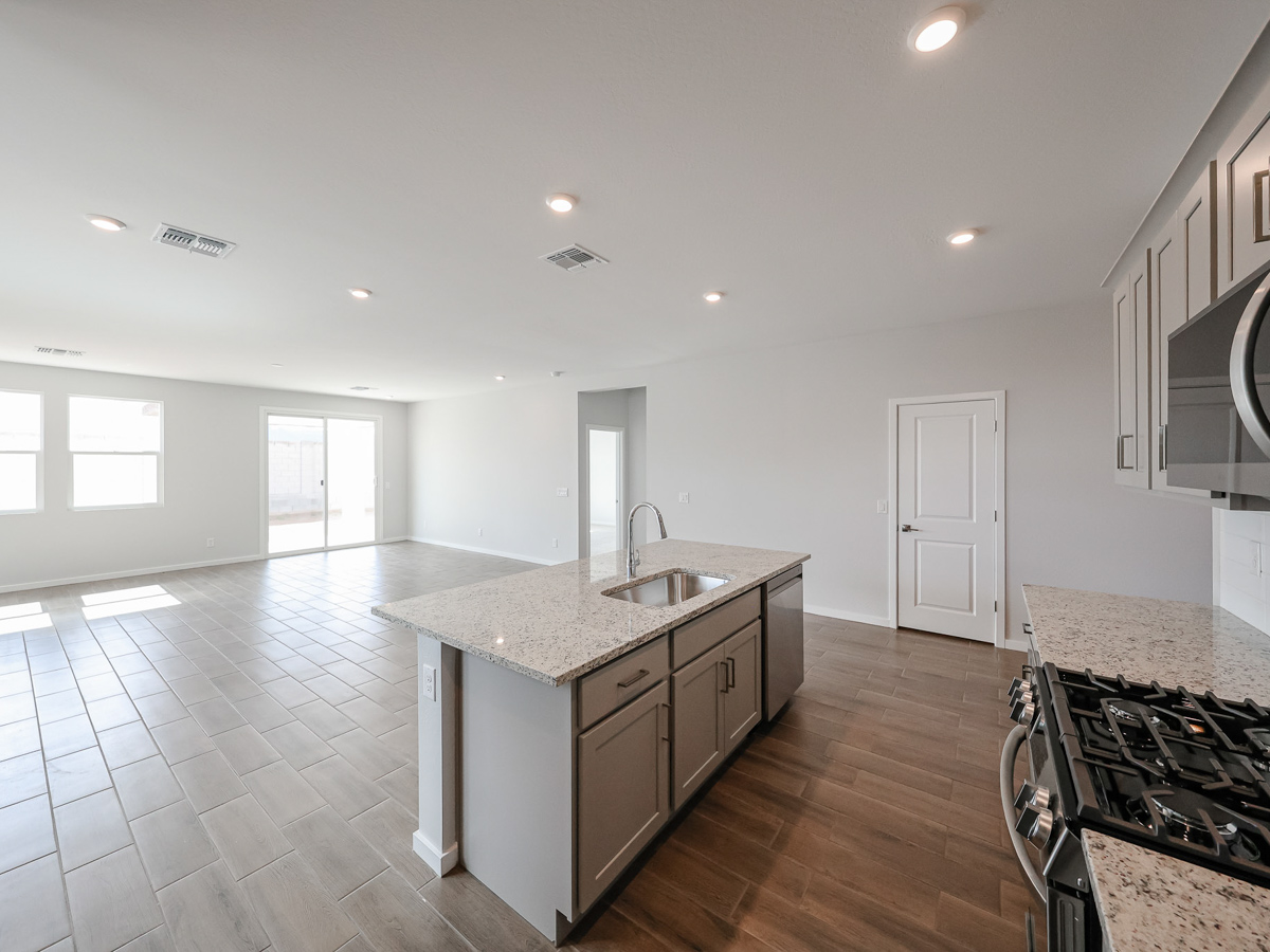 A kitchen with a wood floor.