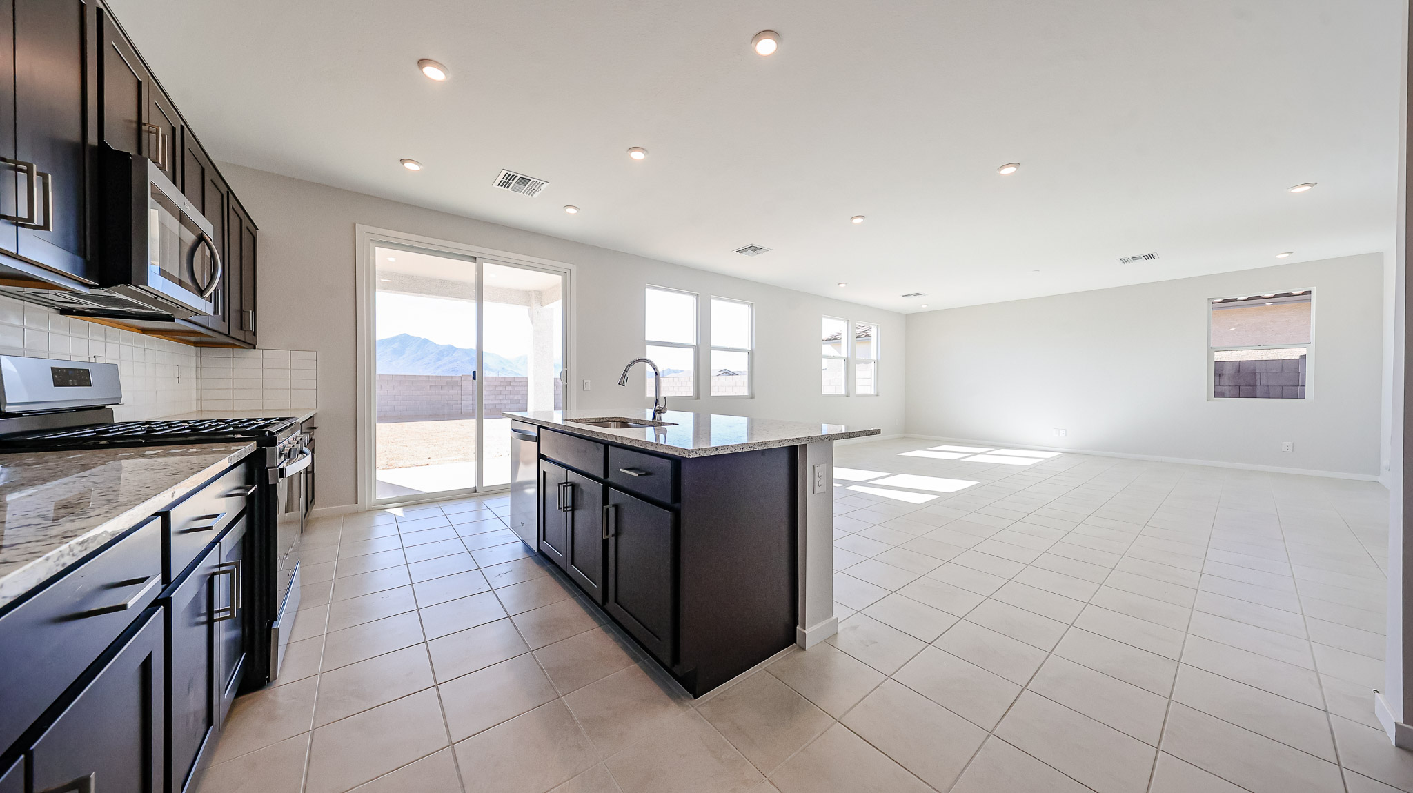 A kitchen with a large window.