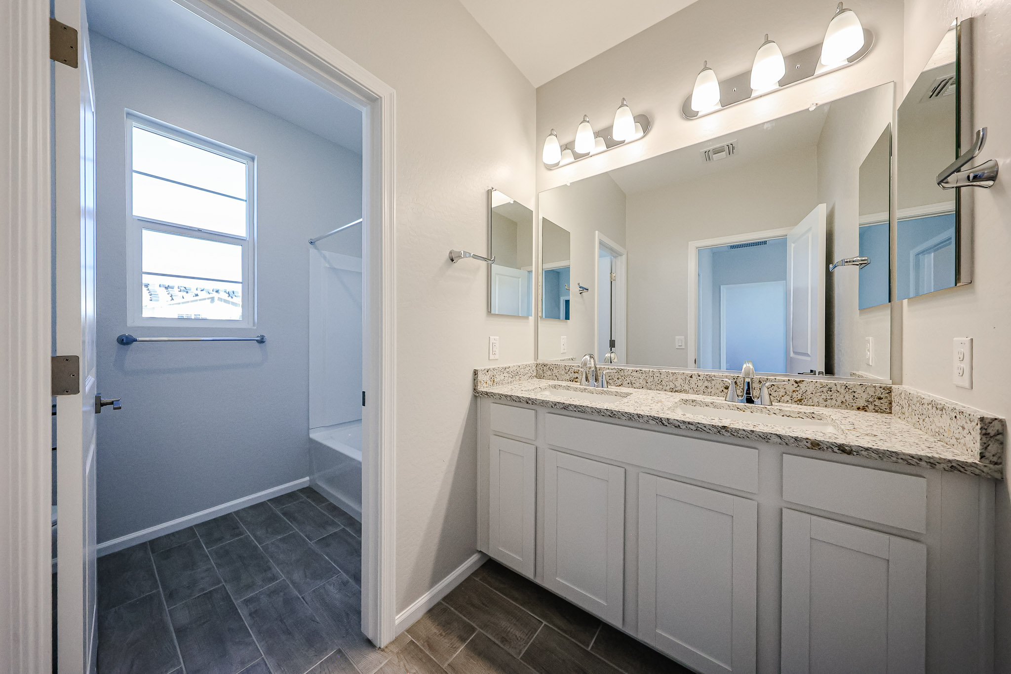 A bathroom with a marble countertop.
