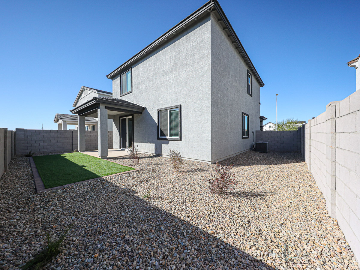A house with a gravel driveway.