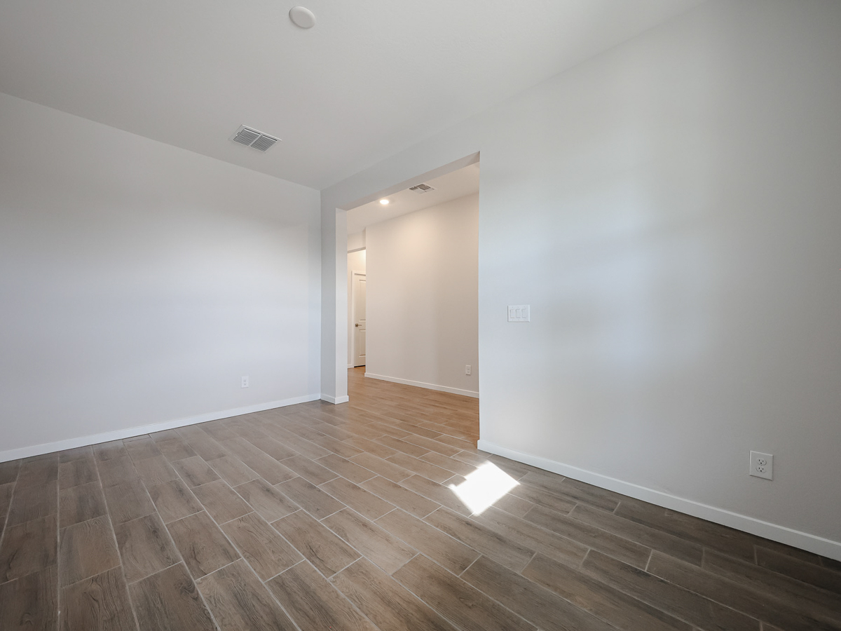 A room with a wood floor and a wood floor.