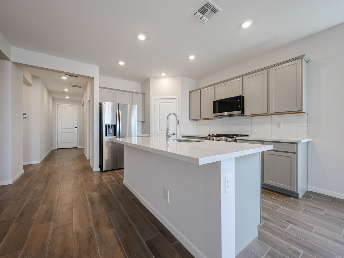 A kitchen with white cabinets.