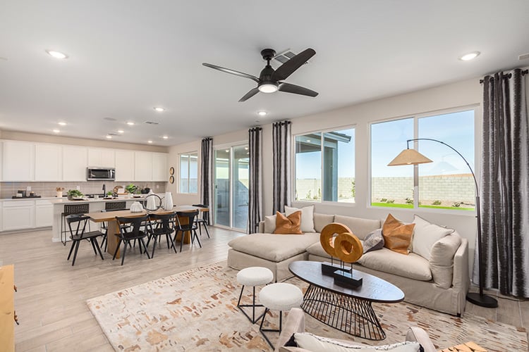 A living room with a large chandelier and a large window.