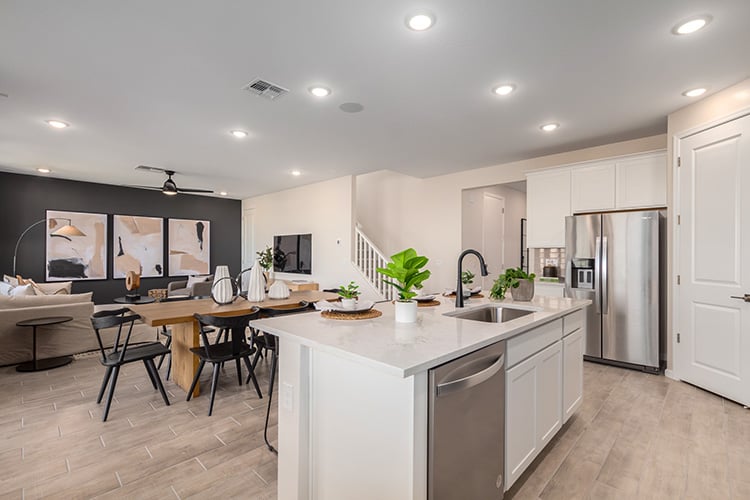 A kitchen with a table and chairs.