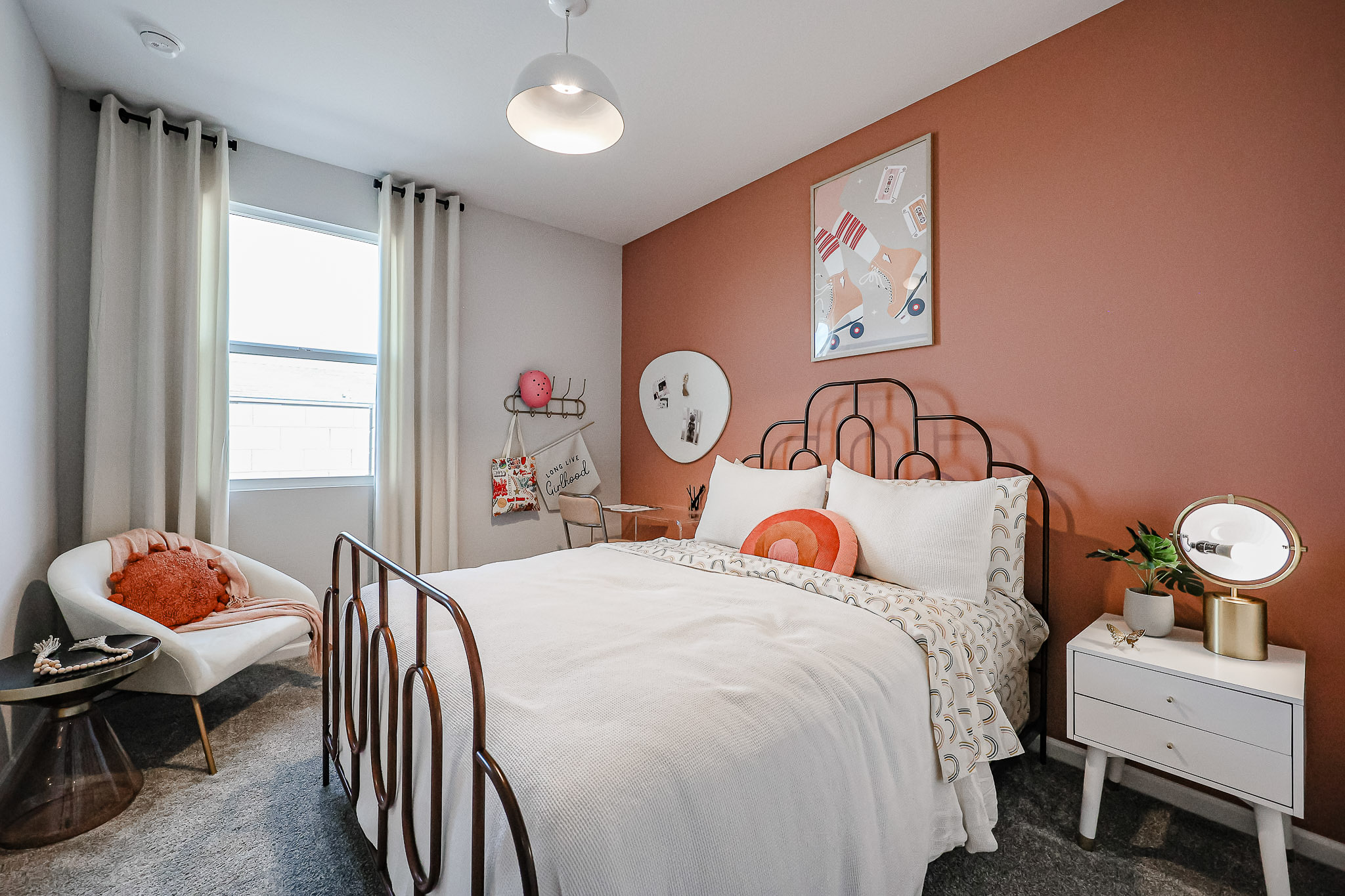 A bedroom with a bed and a chair.