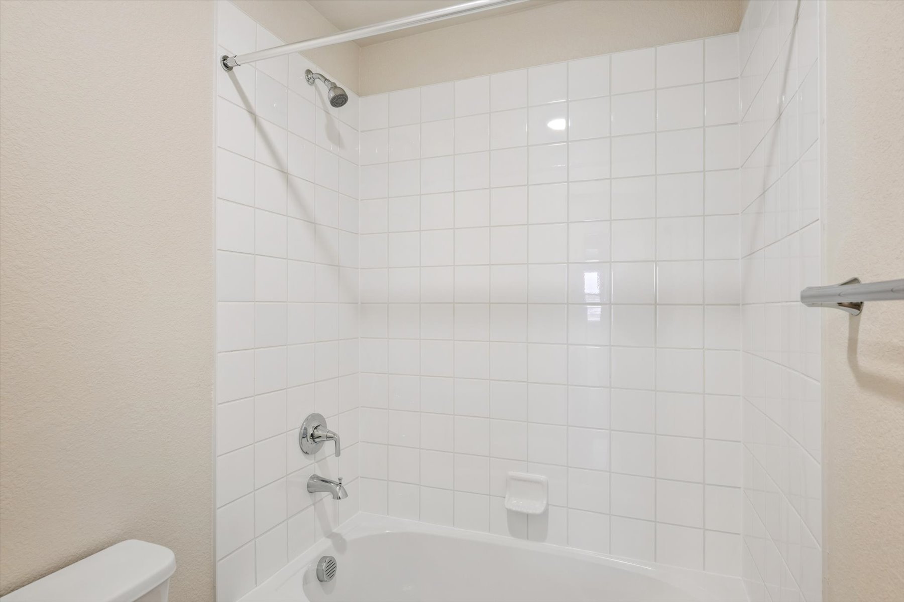 A white tiled bathroom.