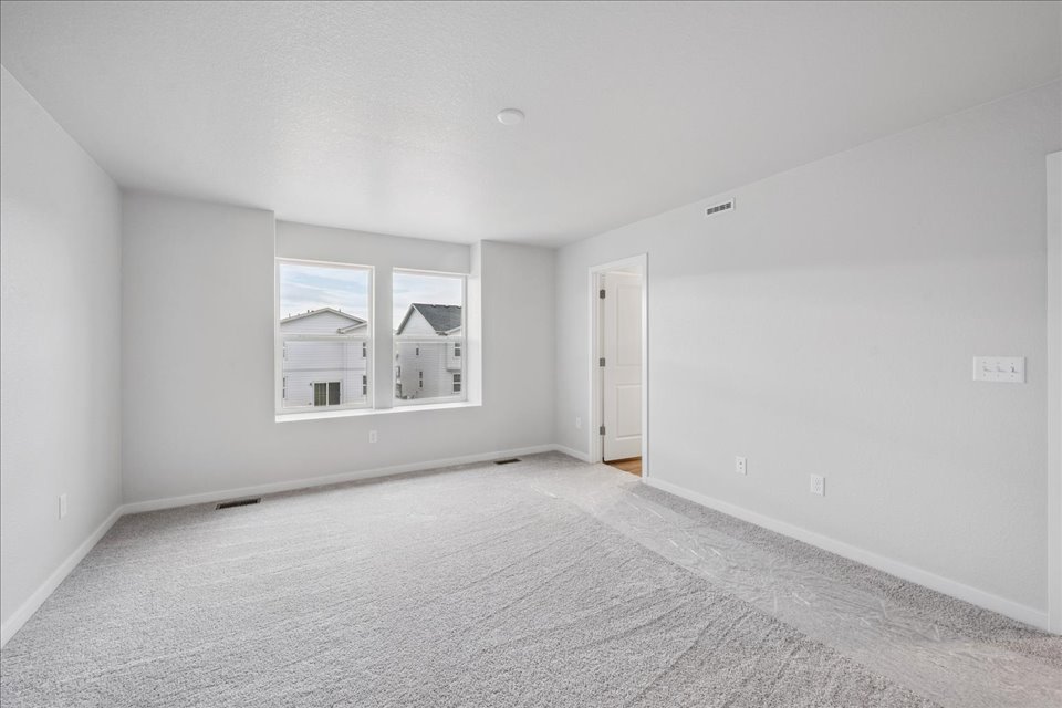 A room with a window and a carpet.