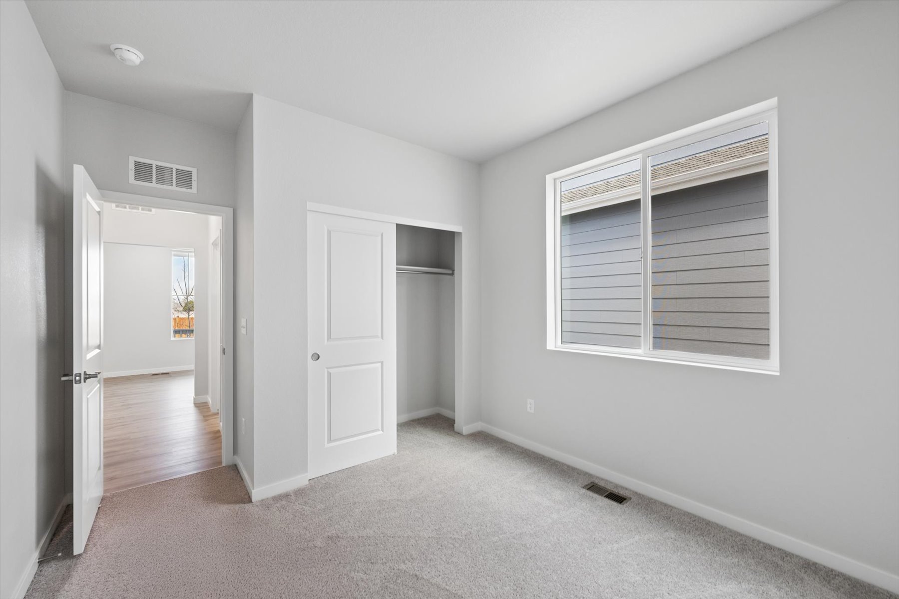 A room with white walls and a window.