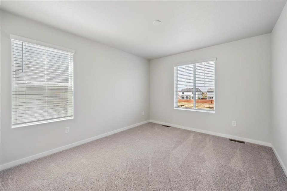 A room with a window and a carpet.