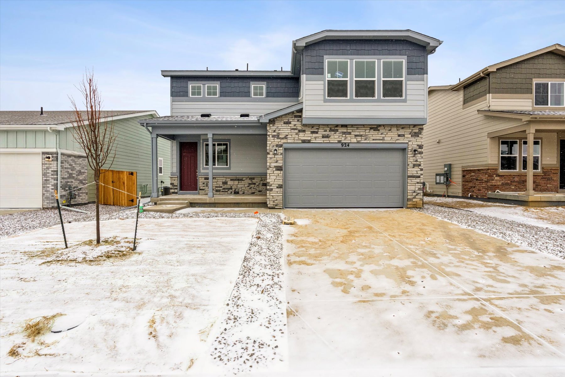 A house with a garage and a fence in the front.