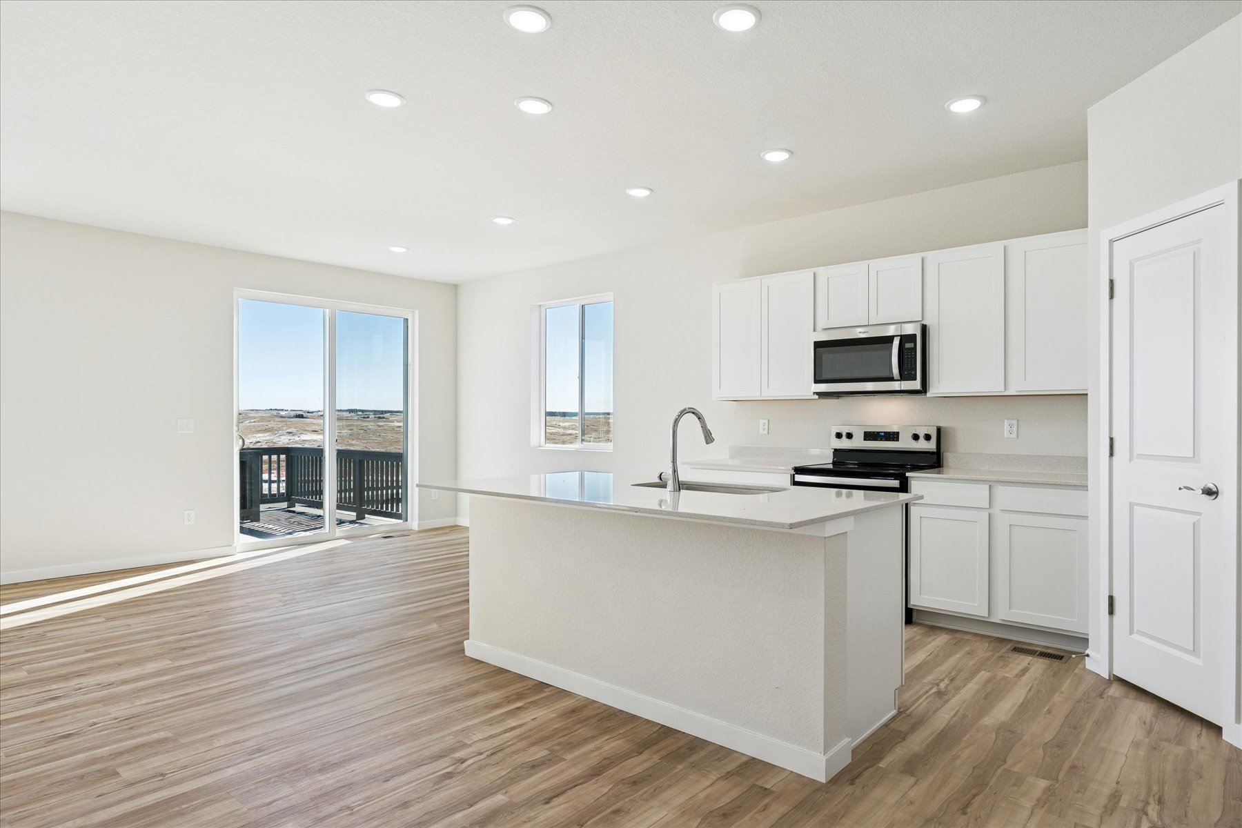 A kitchen with white cabinets.