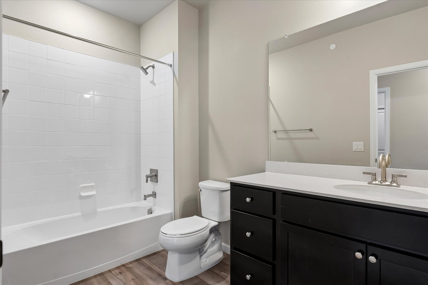 A bathroom with a tub sink and toilet.