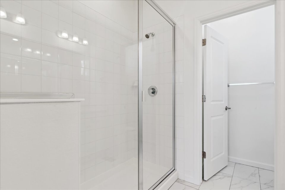 A shower with glass doors.