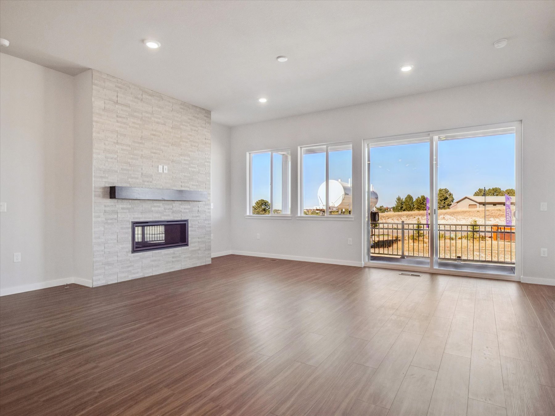 A room with a fireplace and a wood floor.