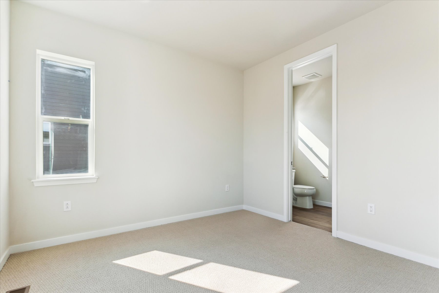 A bathroom with a toilet and a sink.