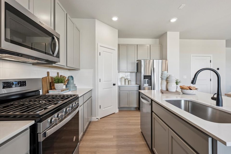 A kitchen with white cabinets.