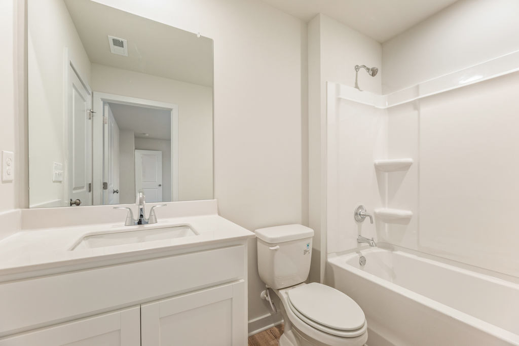 A bathroom with a tub toilet and sink.