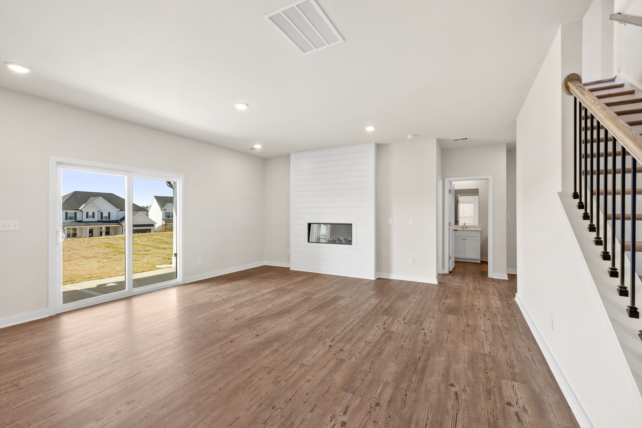 A large empty room with a wood floor.