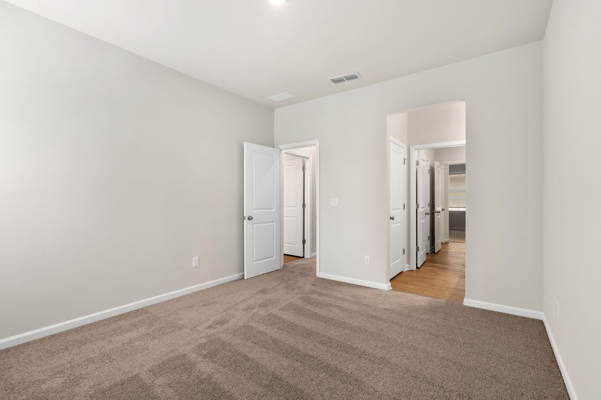 A hallway with white walls.
