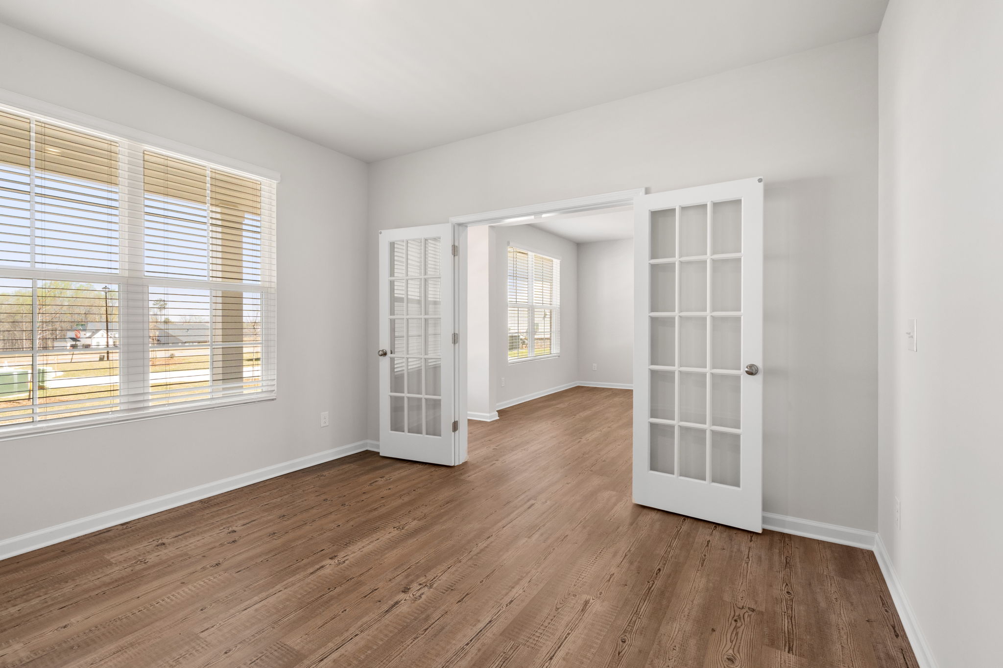 A room with a wood floor and white walls.