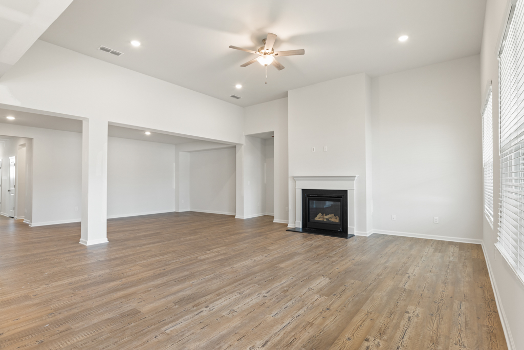 A large empty room with a fireplace.