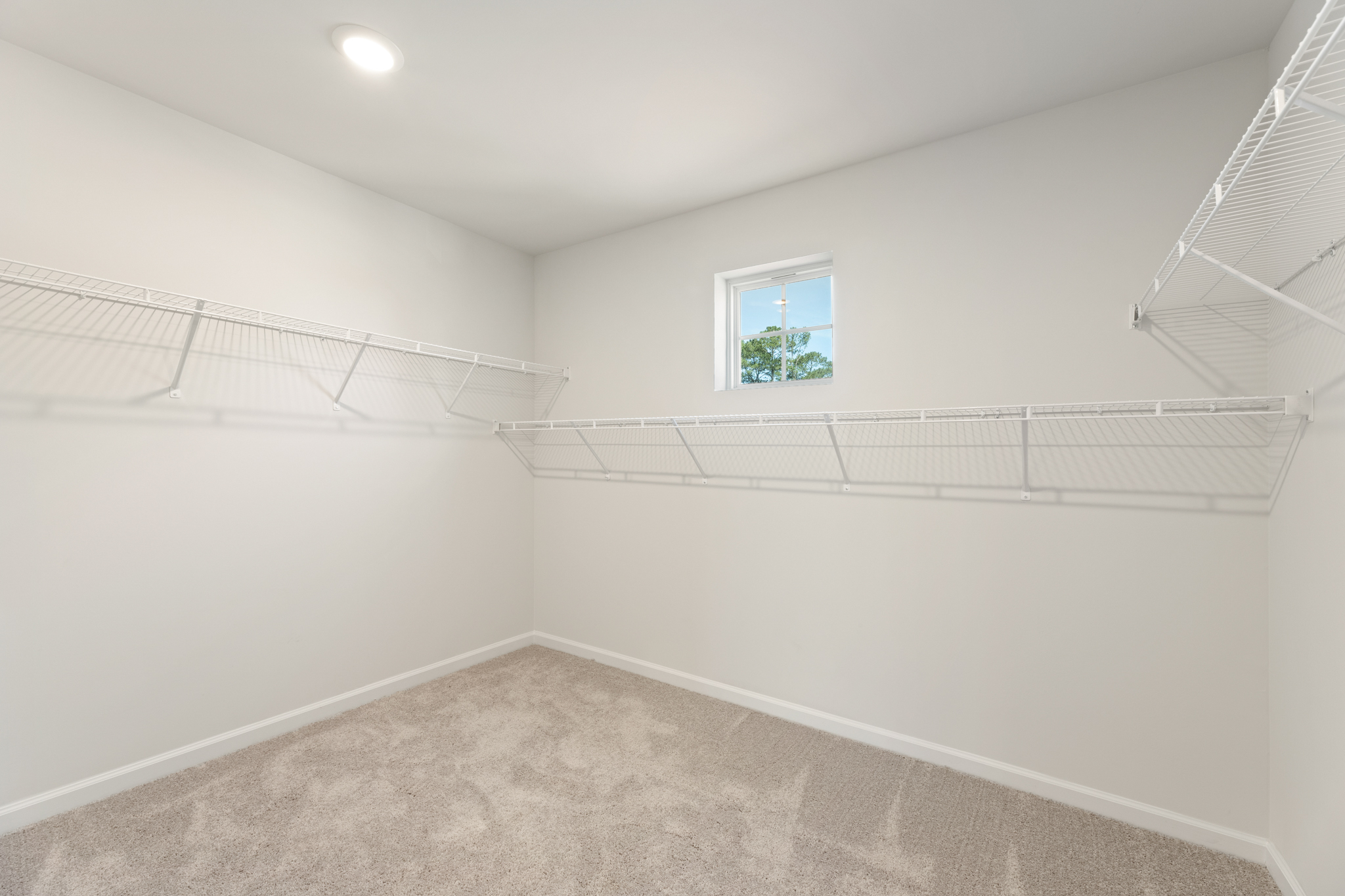 A white room with a window.