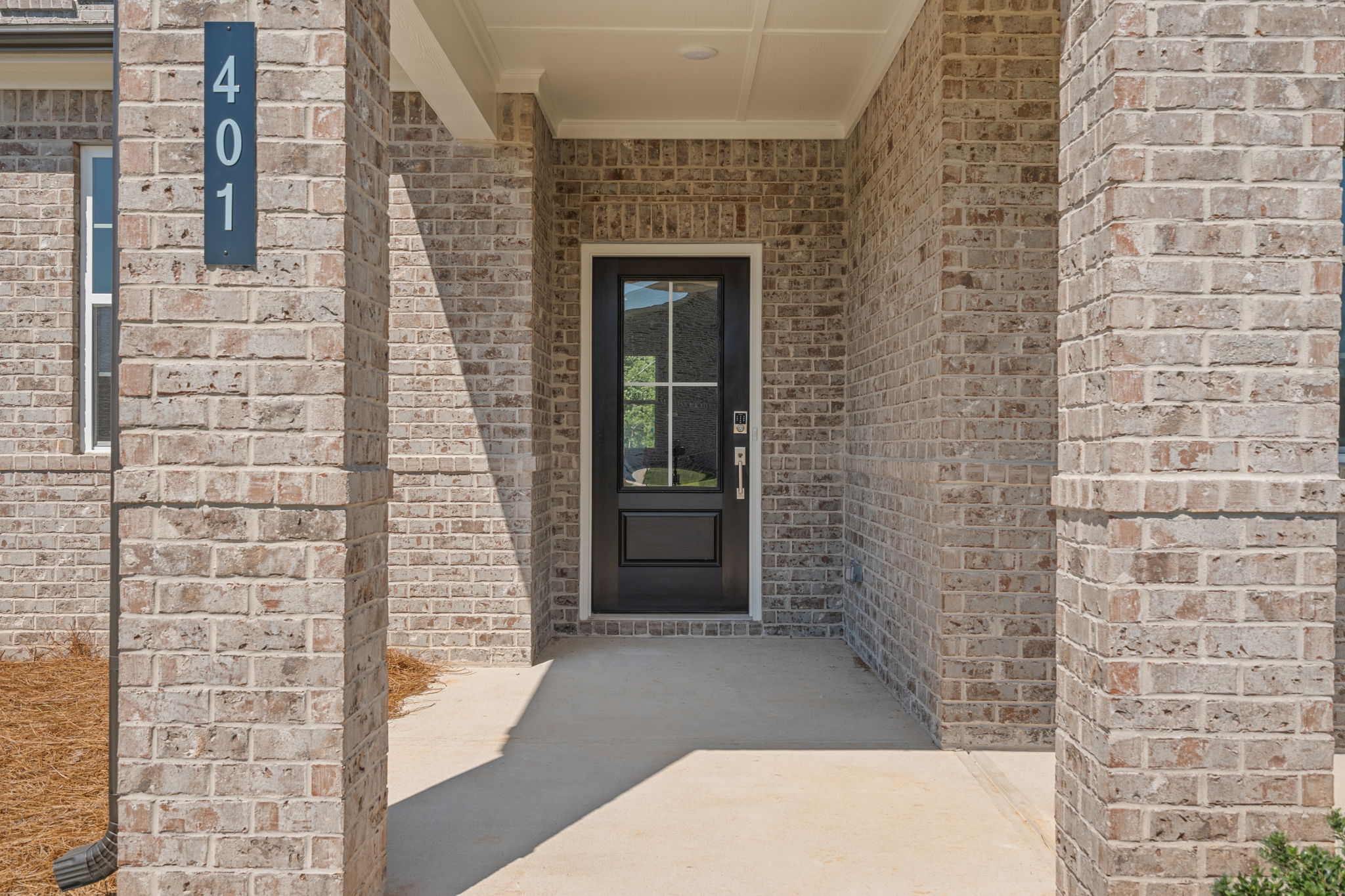 A brick building with a black door.