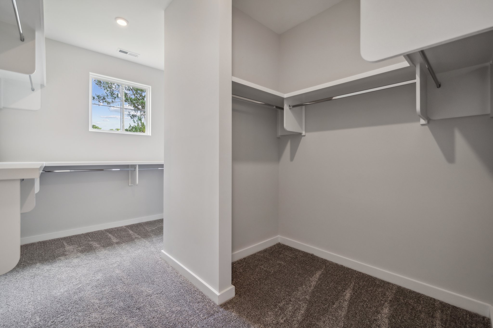 A room with a window and a white wall.