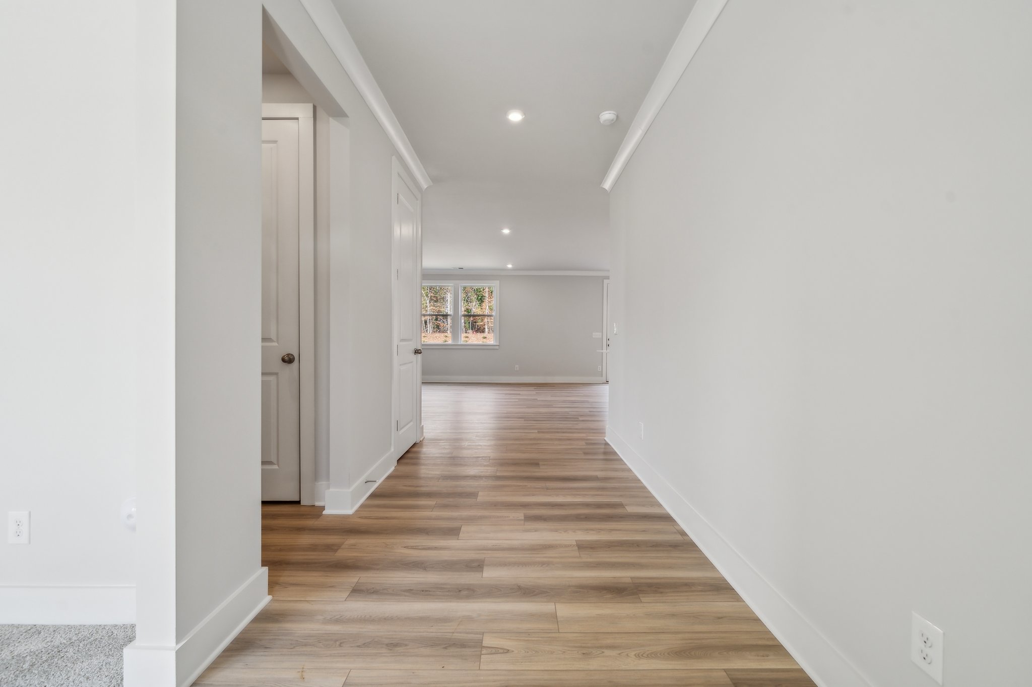 A hallway with white walls.