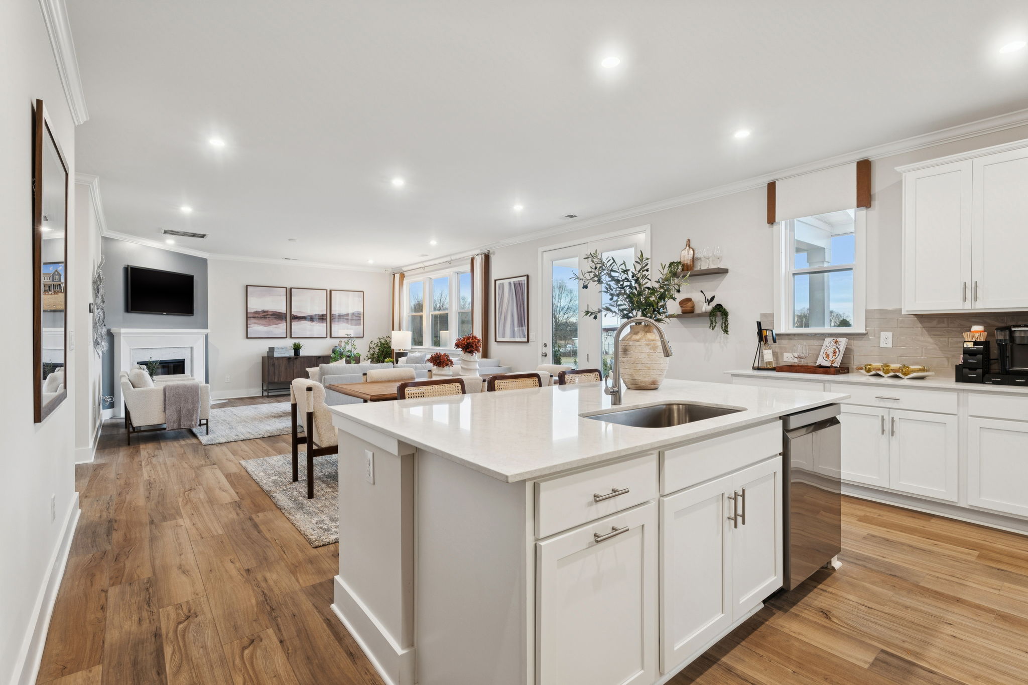A kitchen with white cabinets.
