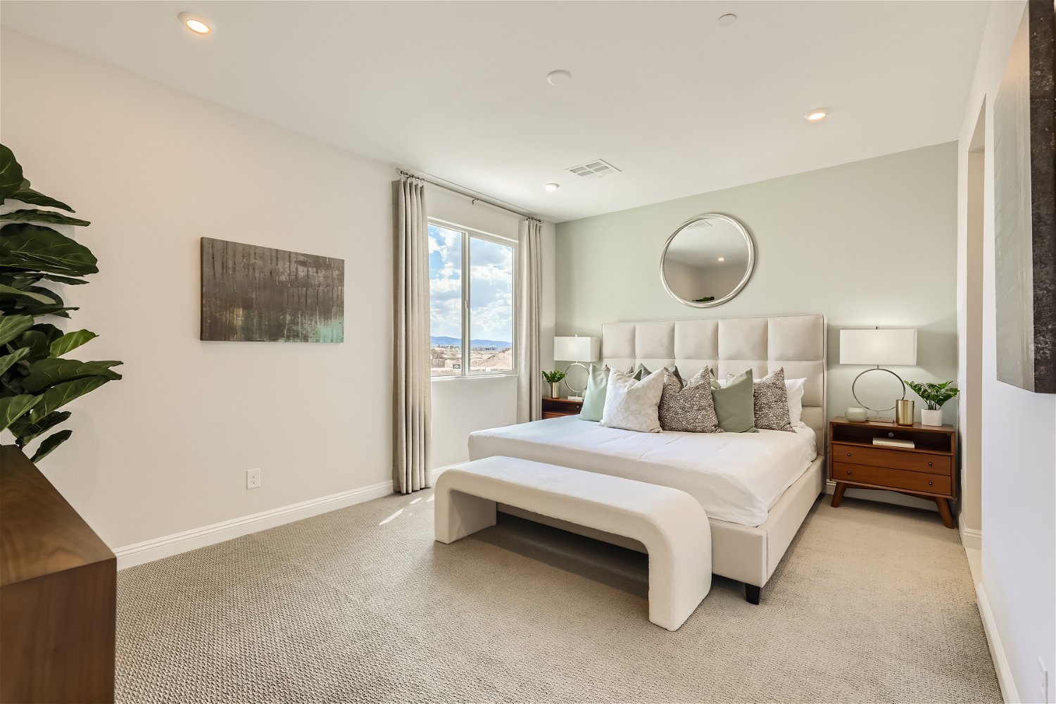 A bedroom with a bed and a mirror.