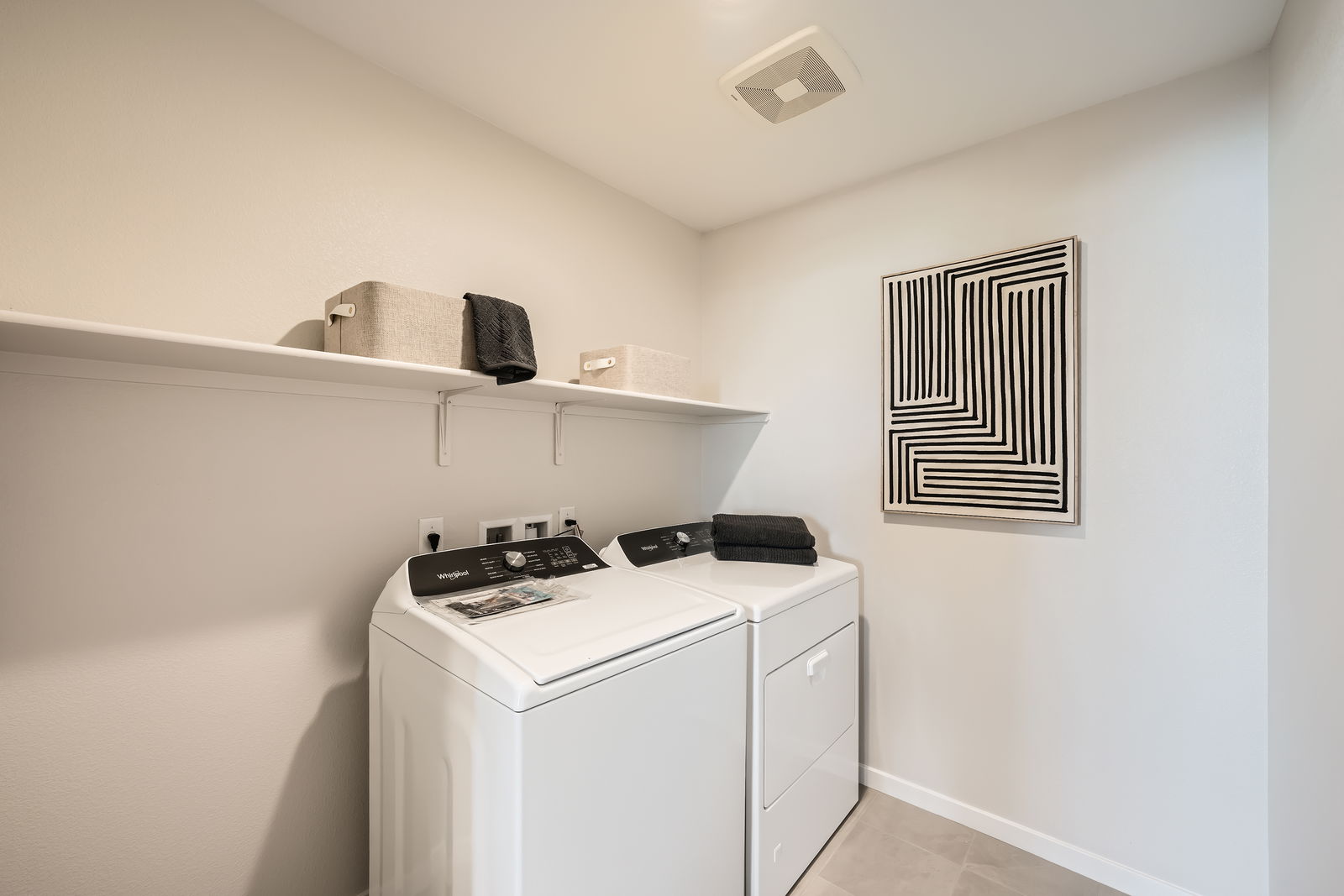 A kitchen with a stove and shelves.