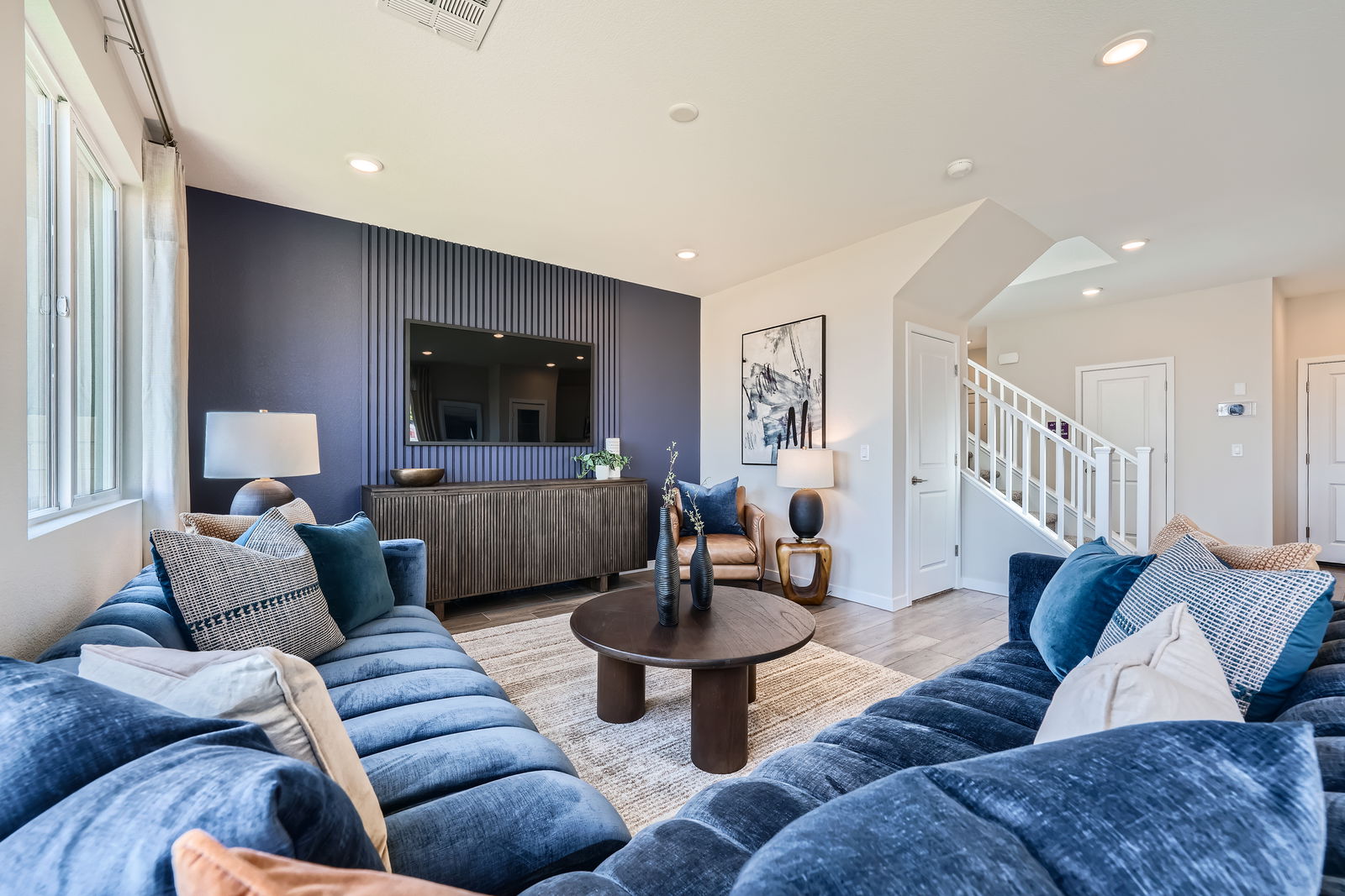 A living room with blue couches.