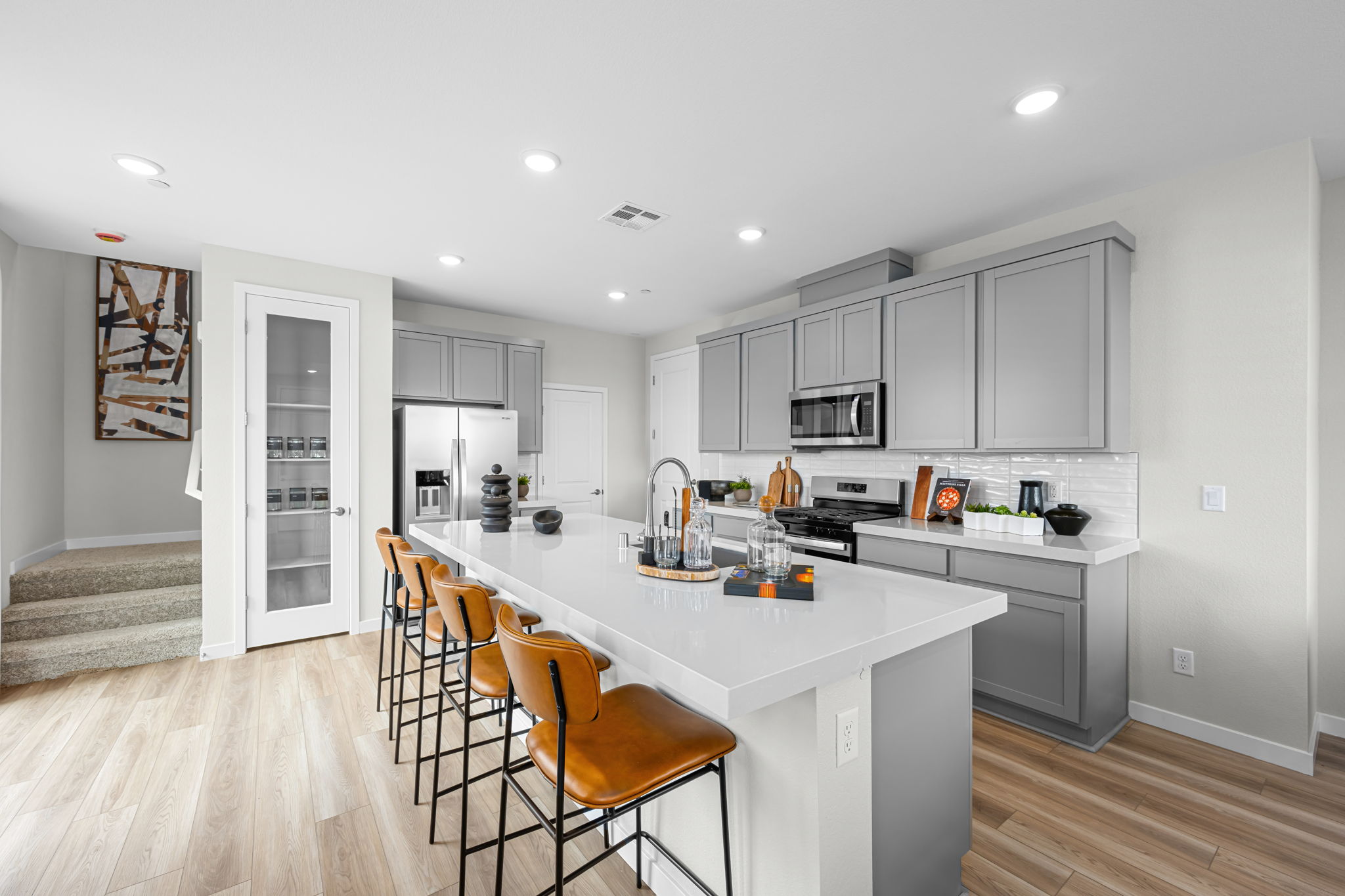 A kitchen with white cabinets.