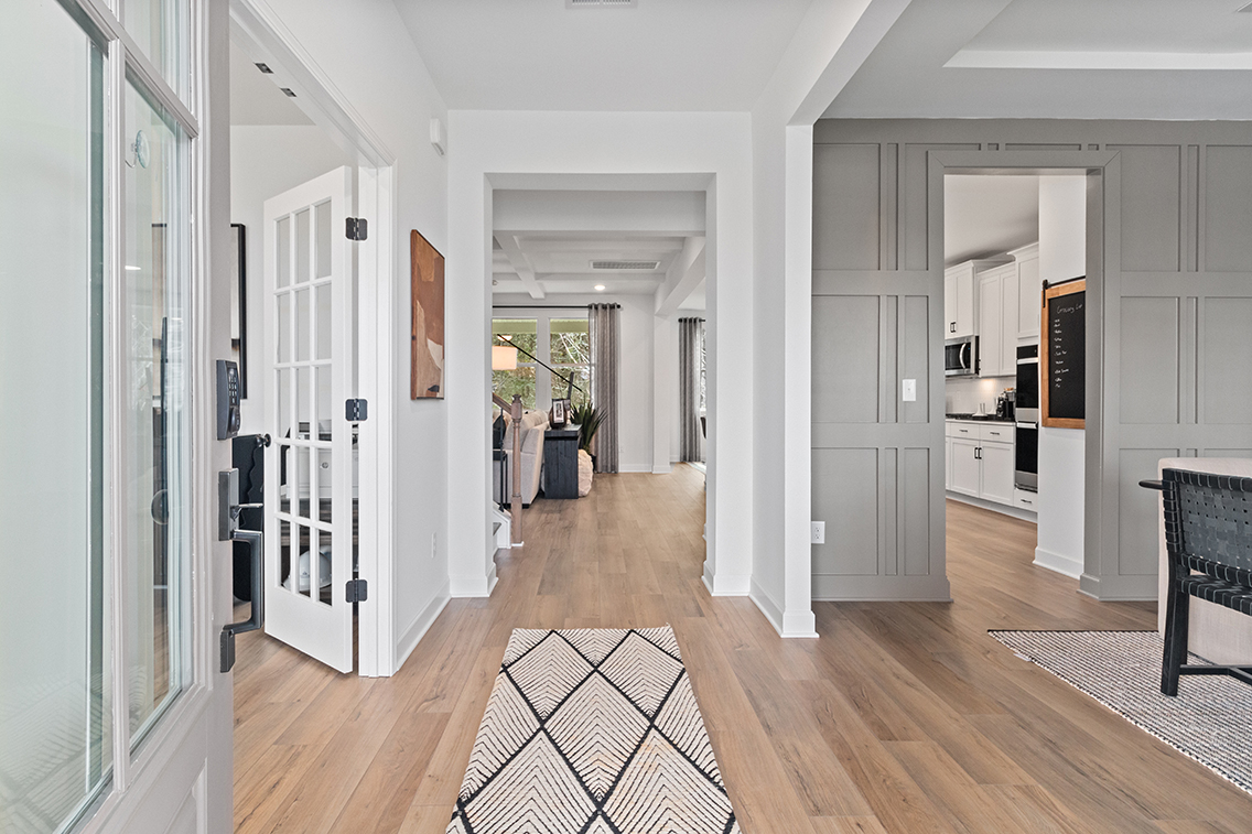 A room with white walls and wood floors.